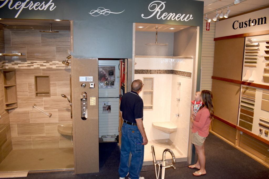 Woman with baby looking at shower display