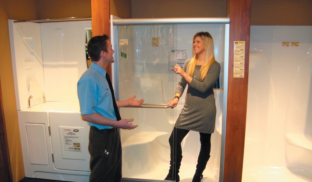 Customer standing in sterling shower with shower door