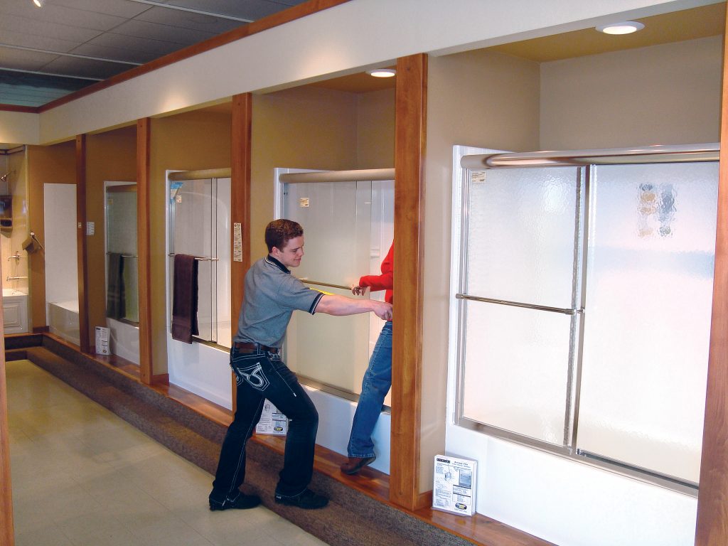 Man measuring shower to fit shower door