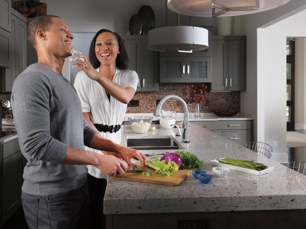 Couple cooking in kitchen with prep sink
