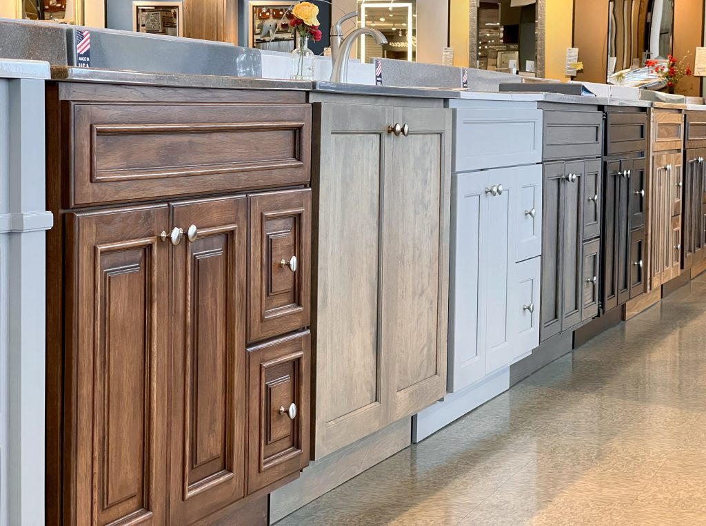 Row of bathroom vanities and vanity tops displayed at floor level in the Handy Man showroom in Sioux Falls, SD
