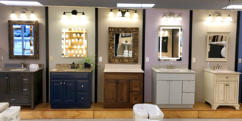 Showroom display vignettes with vanities, vanity tops, lights, and mirrors